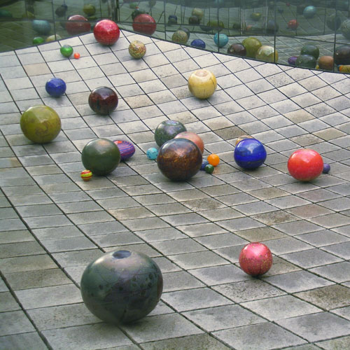 Richard Rhodes' untitled sculpture is installed in the Tacoma Art Museum. It's made from salvaged granite, and has included other artist installations. In this photo, the artist Dale Chihuly has created a temporary exhibit called "Nijima Floats" to sit on Rhodes' wave. Photo: Richard Rhodes