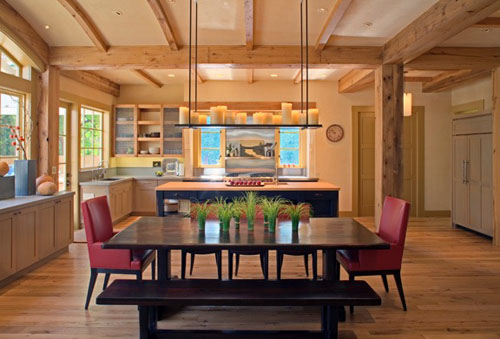 Architect David Ludwig believes that overly perfect designs need a little bit of surprise, like fallen leaves in a Zen garden. A black island with a butcher block top, and the contrasting furniture in the foreground, add boldness to break up the neutrality in a kitchen of light cabinets with grey stone tops.