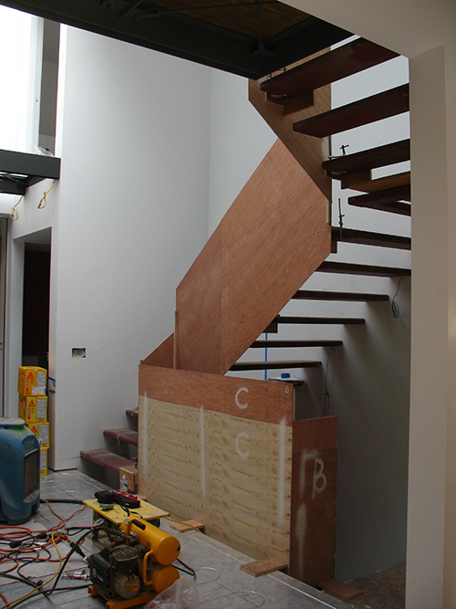 Physical mockups help the architect determine the exact pattern needed for fabrication of custom stair panels. Ascent as viewed from the main floor. Image: Mark English Architects