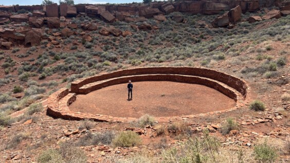 Circular stone ruins of an ancient ceremonial gathering area in desert terrain