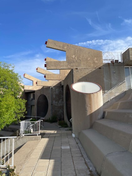 Modest concrete residential units with small windows built into hillside