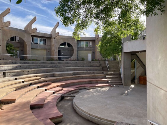 Tiered outdoor amphitheater seating with residential structures visible above